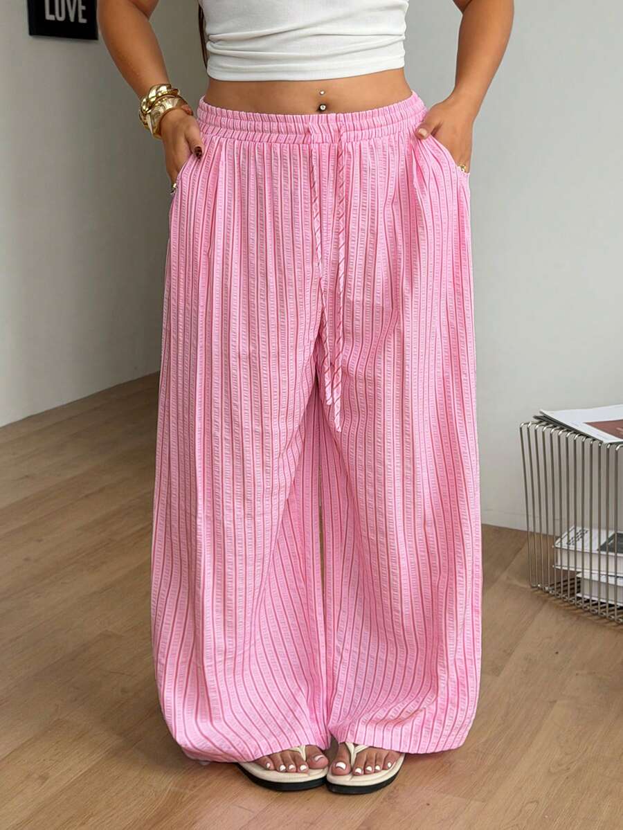 Plus size women's striped loose straight leg cropped pants with pleated detailing and side pockets