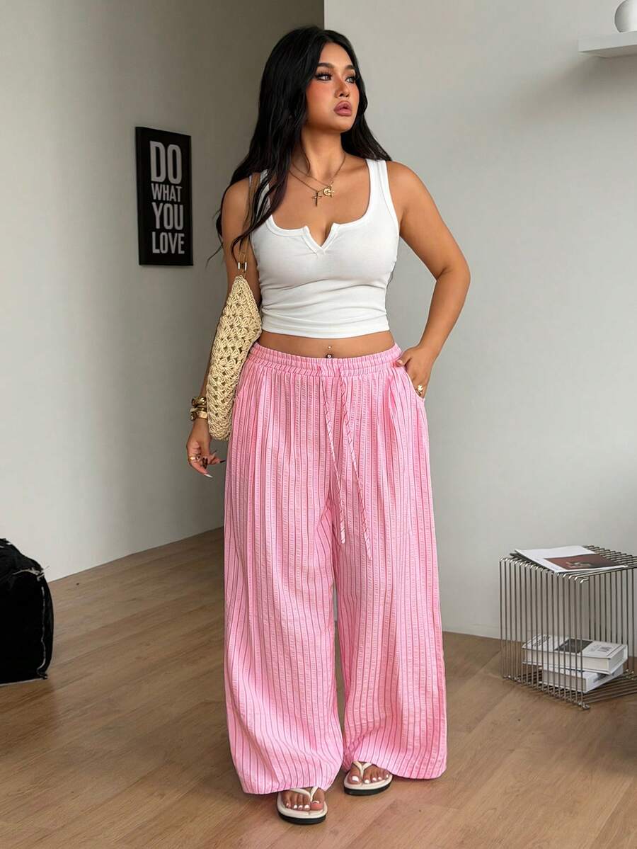 Plus size women's striped loose straight leg cropped pants with pleated detailing and side pockets