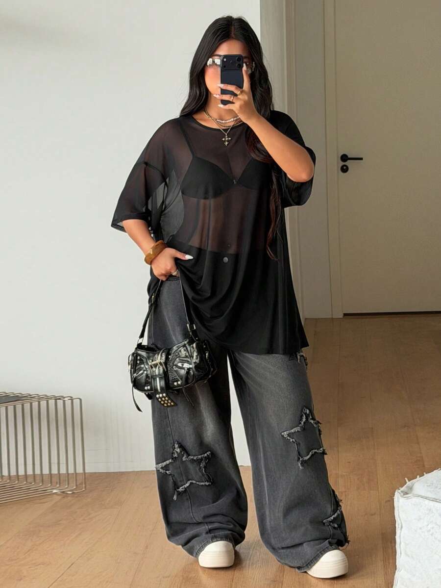 Women's plus size black sheer mesh top featuring a loose fit, round neck, and drop shoulder half sleeves.