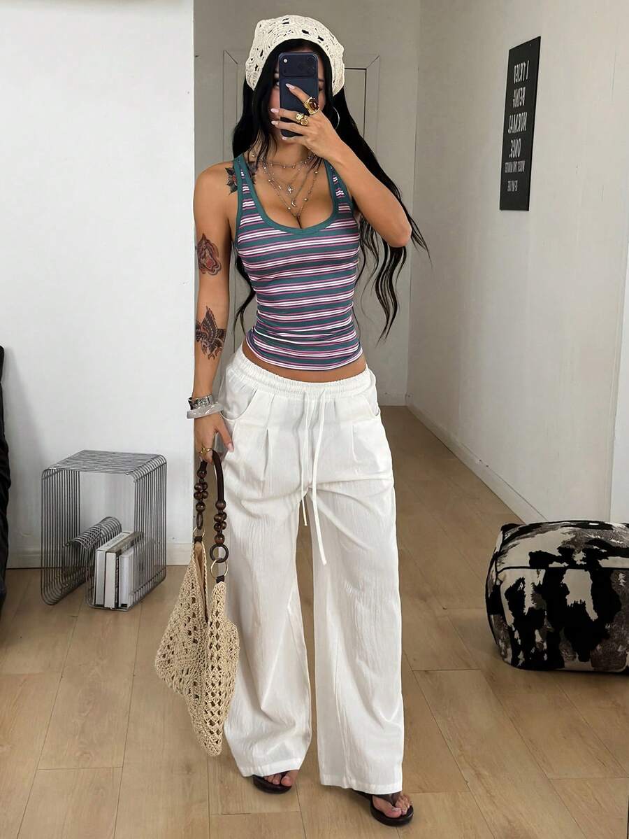 Women's slim fit ruched tank top featuring a scoop neckline in lightweight stretch knitted fabric.