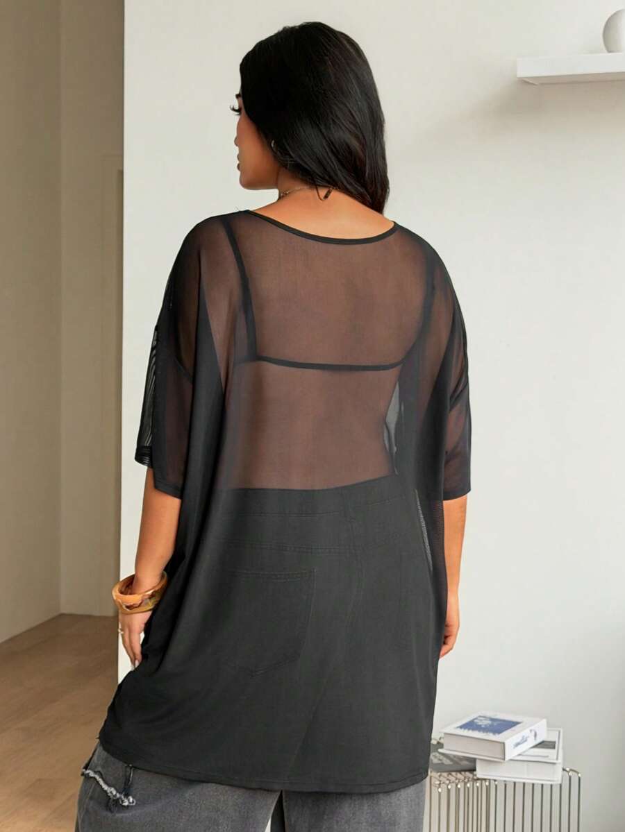 Women's plus size black sheer mesh top featuring a loose fit, round neck, and drop shoulder half sleeves.
