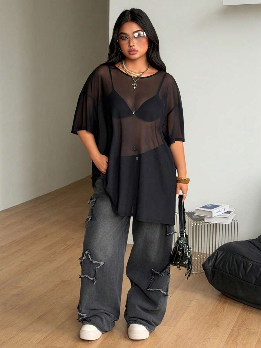 Women's plus size black sheer mesh top featuring a loose fit, round neck, and drop shoulder half sleeves.