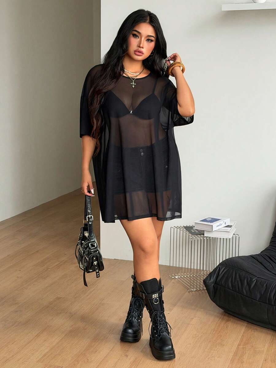 Women's plus size black sheer mesh top featuring a loose fit, round neck, and drop shoulder half sleeves.
