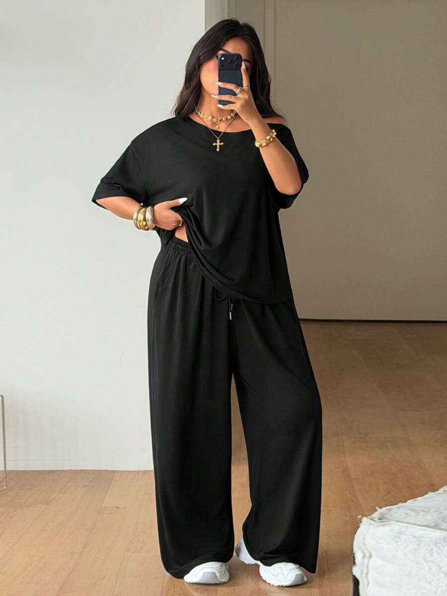 Women's two-piece lounge set featuring a loose drop shoulder asymmetrical neck short sleeve t-shirt and wide-leg knit pants with pockets.