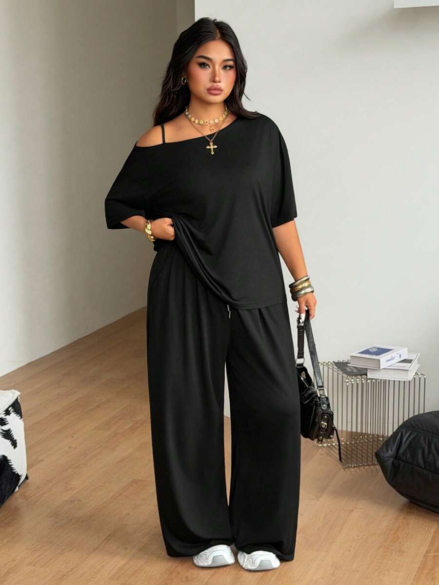 Women's two-piece lounge set featuring a loose drop shoulder asymmetrical neck short sleeve t-shirt and wide-leg knit pants with pockets.