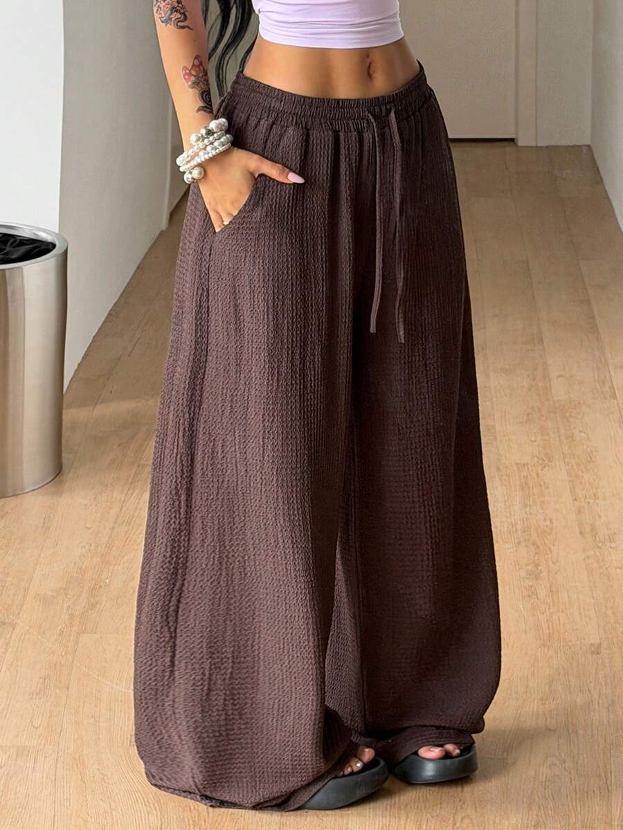 Women's loose fit straight leg lounge pants in textured knit fabric featuring an elastic drawstring waist and side pockets