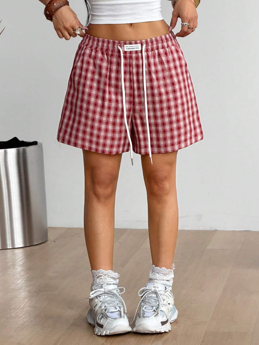 Women's casual drawstring track shorts featuring front pockets and embroidered details