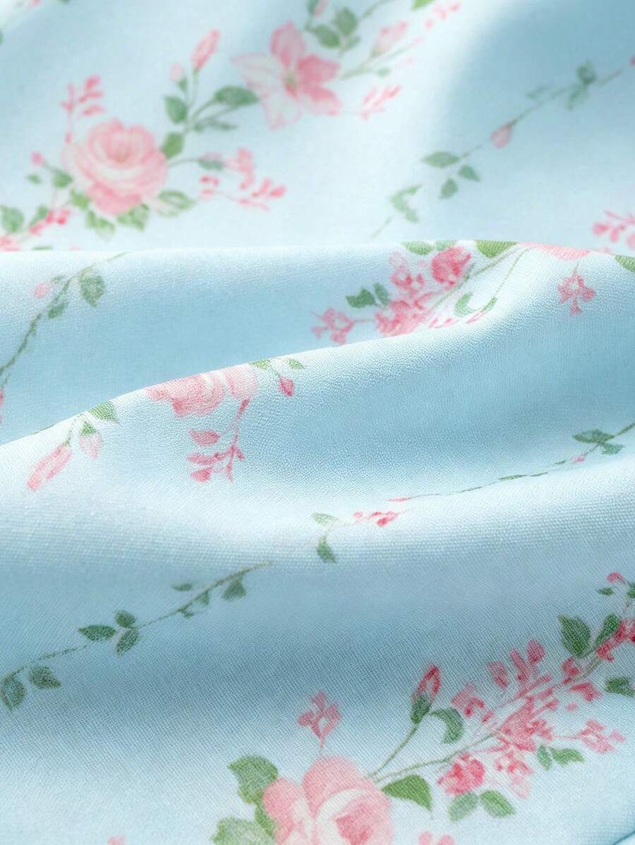 Vintage ditsy floral print sleeveless women's blouse with square neck, ruffle trim, and slim fit style.