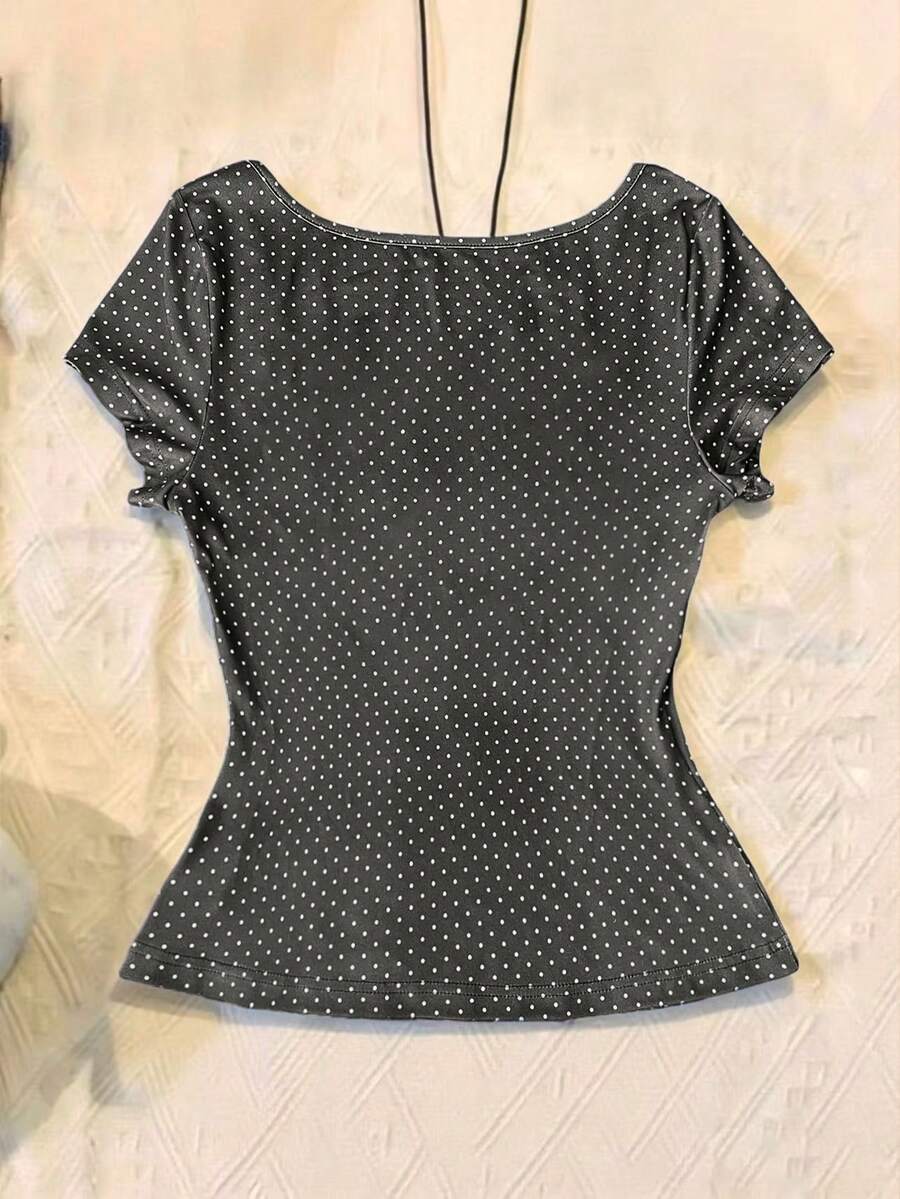 Women's polka dot short sleeve raglan t-shirt with a twist front detail and contrast collar.