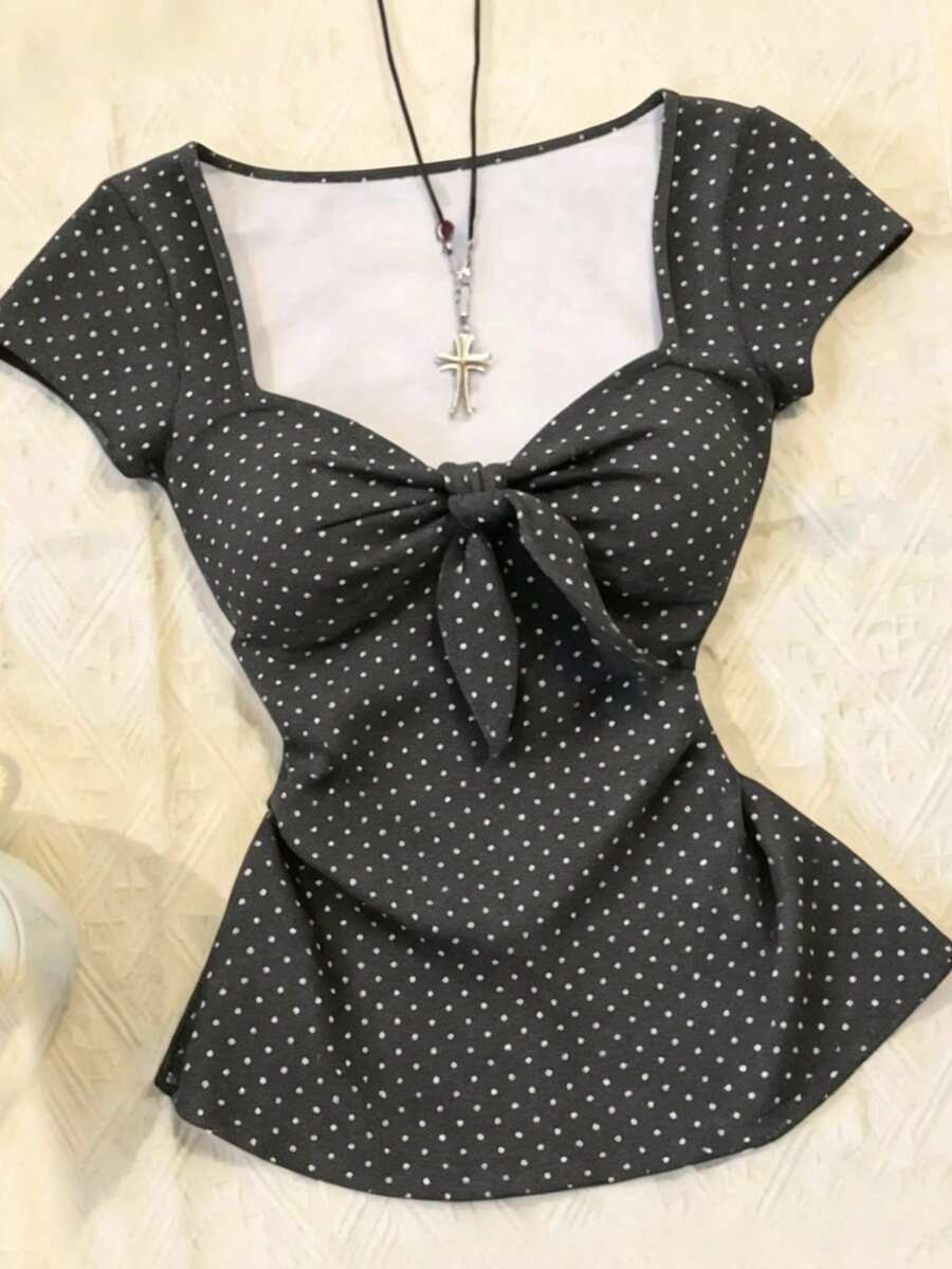 Women's polka dot short sleeve raglan t-shirt with a twist front detail and contrast collar.