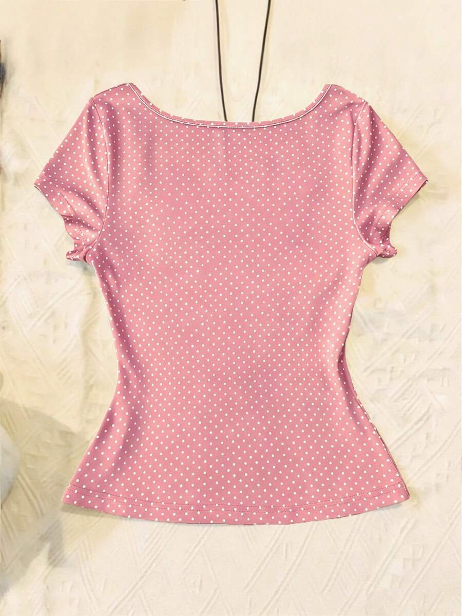 Women's polka dot short sleeve raglan t-shirt with a twist front detail and contrast collar.