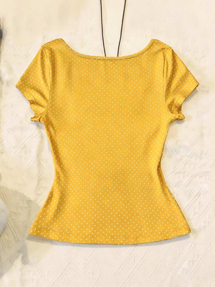 Women's polka dot short sleeve raglan t-shirt with a twist front detail and contrast collar.