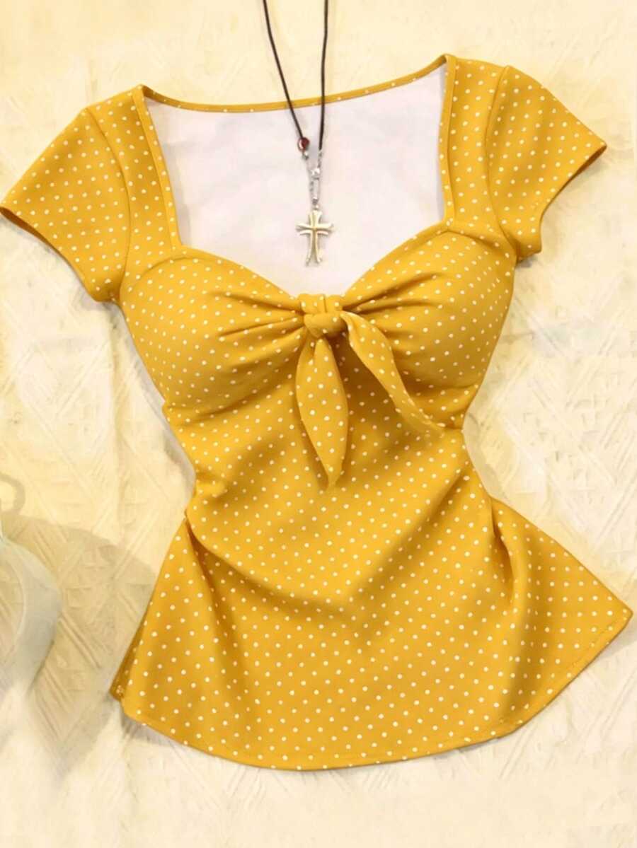 Women's polka dot short sleeve raglan t-shirt with a twist front detail and contrast collar.