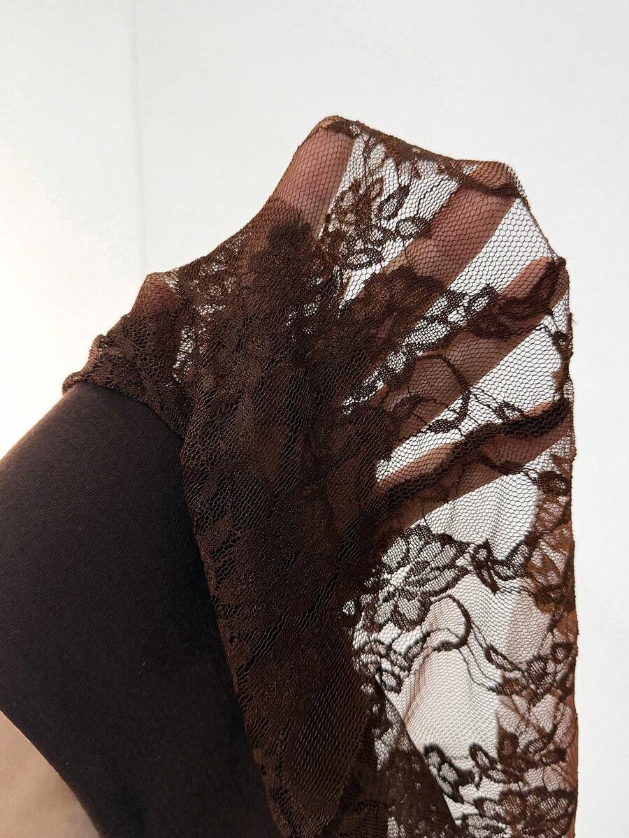 Women's black semi-sheer lace asymmetrical skirt with fringe details, contrast lace, low waist, and ruffle hem for beach, party, concert, or festival outfits.