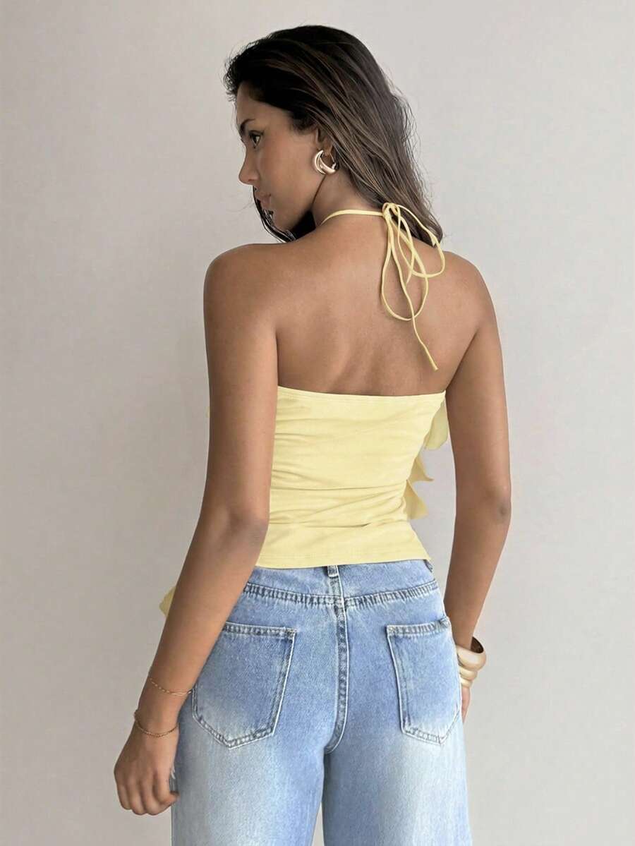 Women's sleeveless halter neck top featuring tiered ruffle layers, a backless cut, and an asymmetrical hem.