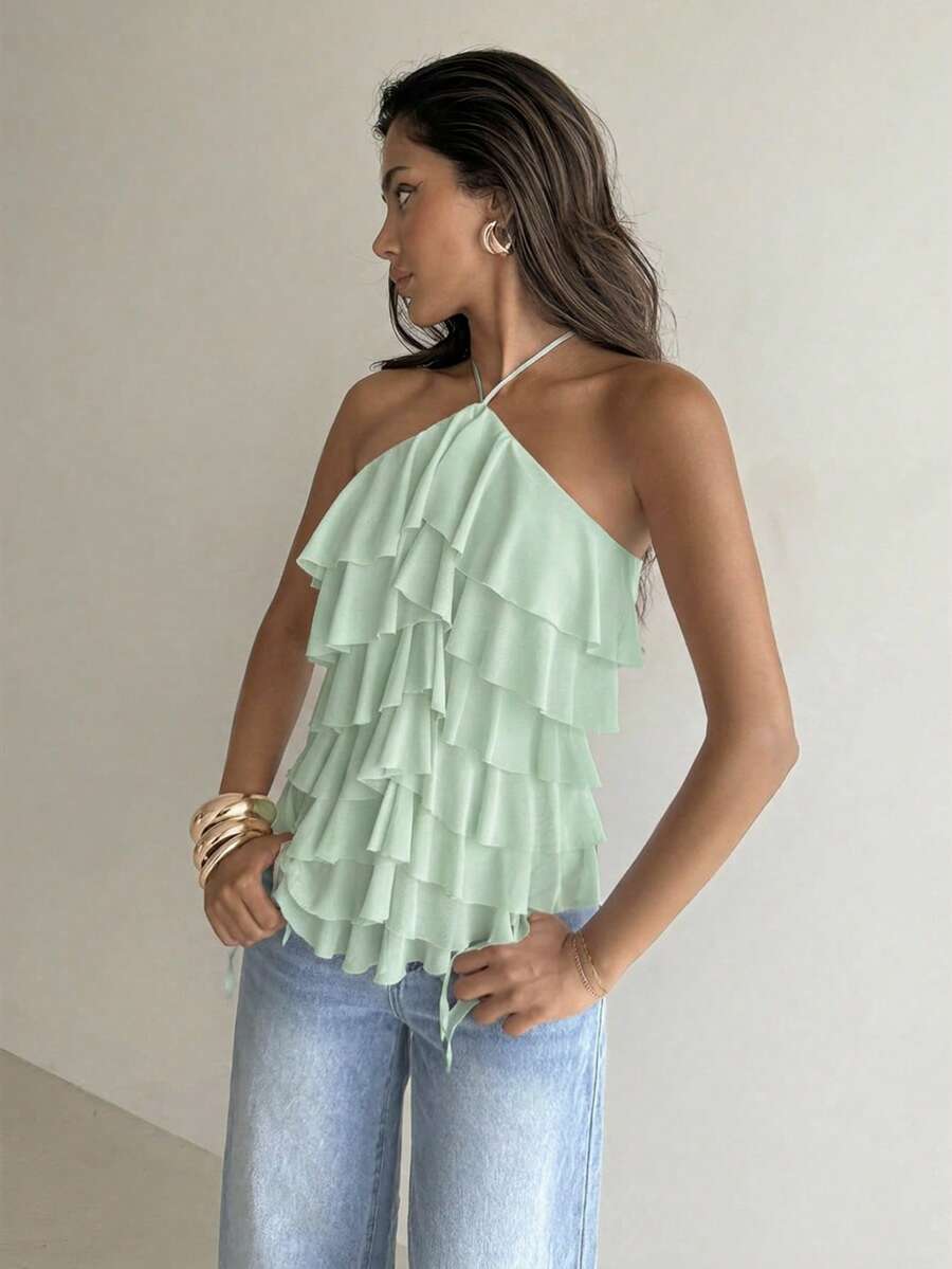 Women's sleeveless halter neck top featuring tiered ruffle layers, a backless cut, and an asymmetrical hem.