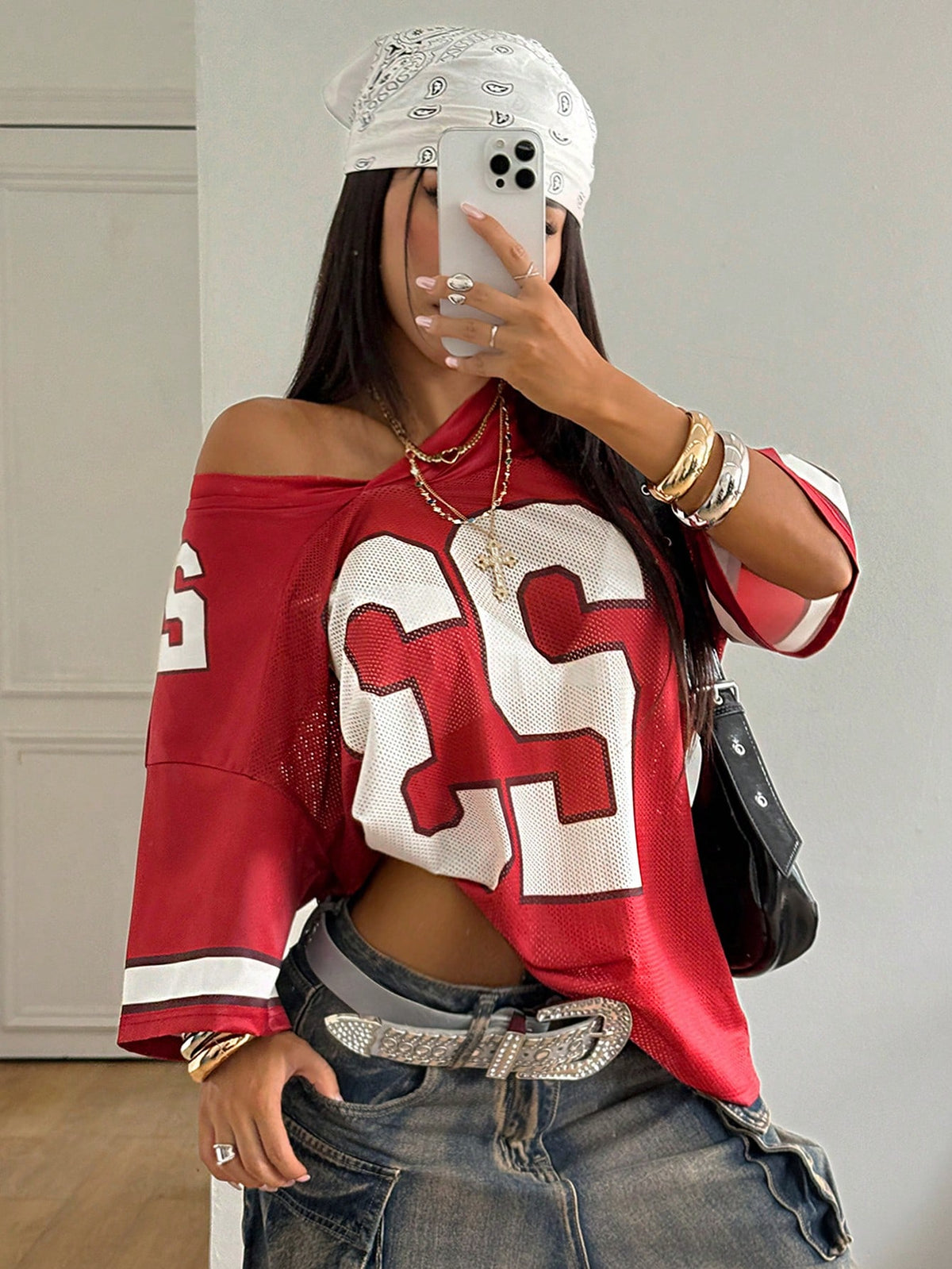 Oversized short-sleeve football jersey top featuring a V-neckline, contrast binding, and graphic number print.