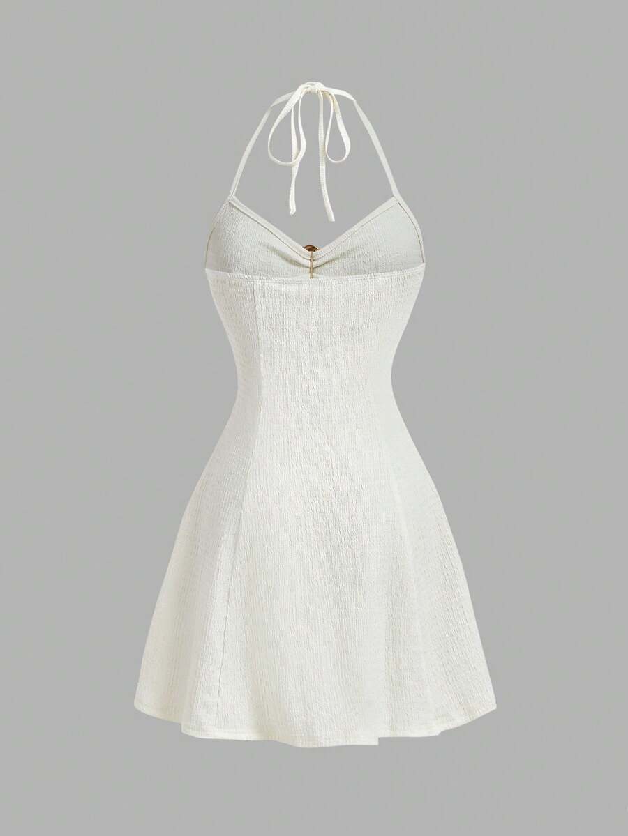 Women's apricot halter mini dress with backless knot and ring detail, sleeveless cami style, flared hem, and boho vacation look