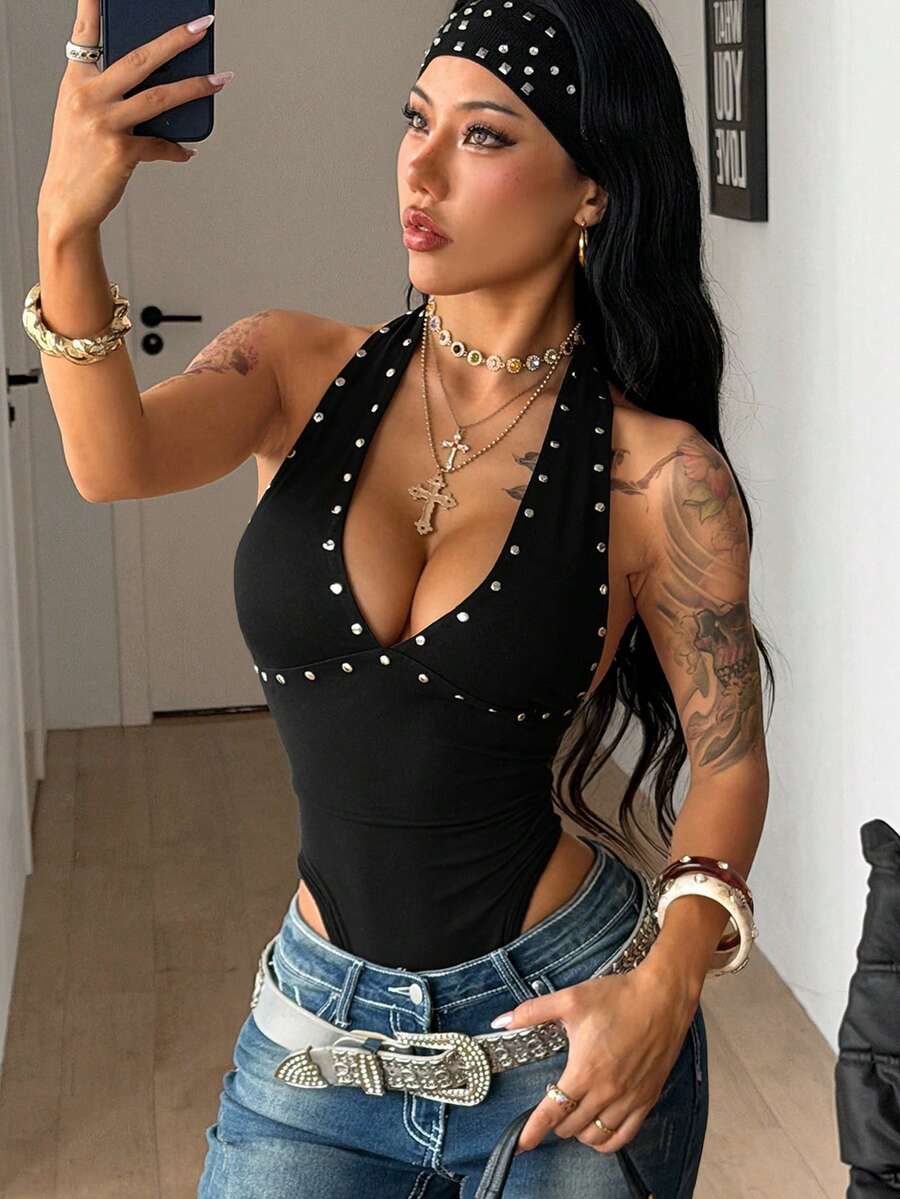 Women's black halter bodysuit featuring silver studded rivet details on a stretchy slim-fit sleeveless top.