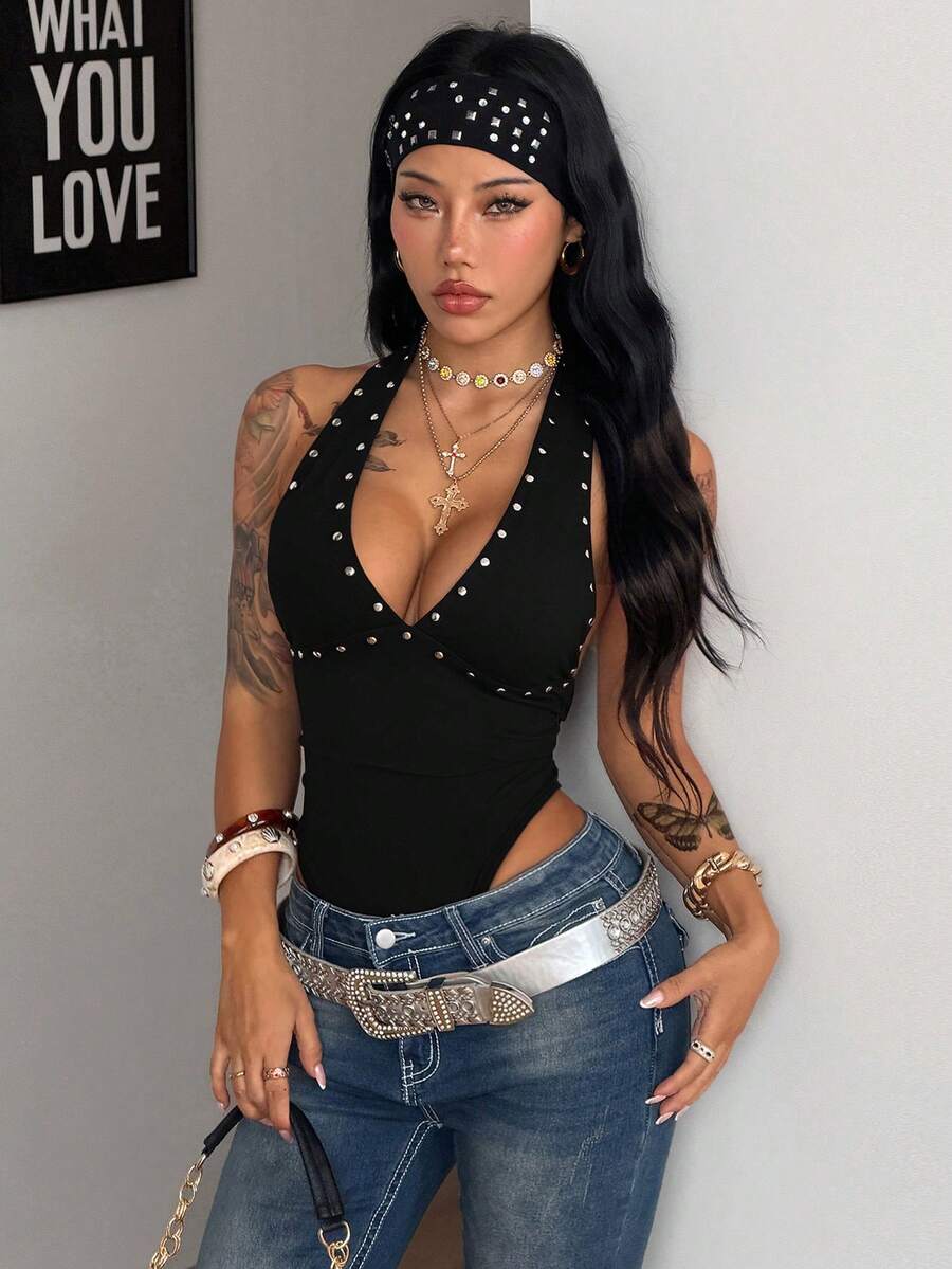 Women's black halter bodysuit featuring silver studded rivet details on a stretchy slim-fit sleeveless top.