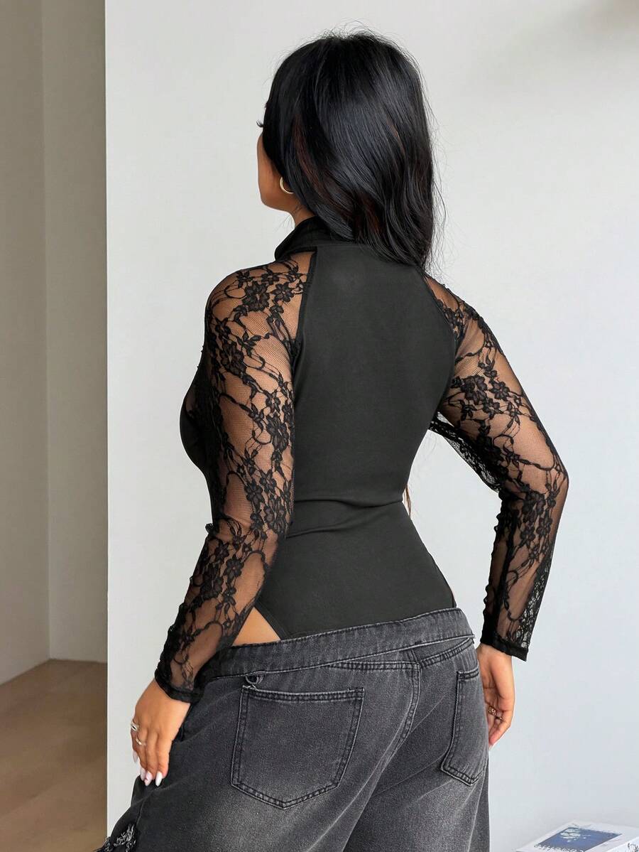 Women's black long sleeve bodysuit with sheer contrast lace raglan sleeves and stand collar.