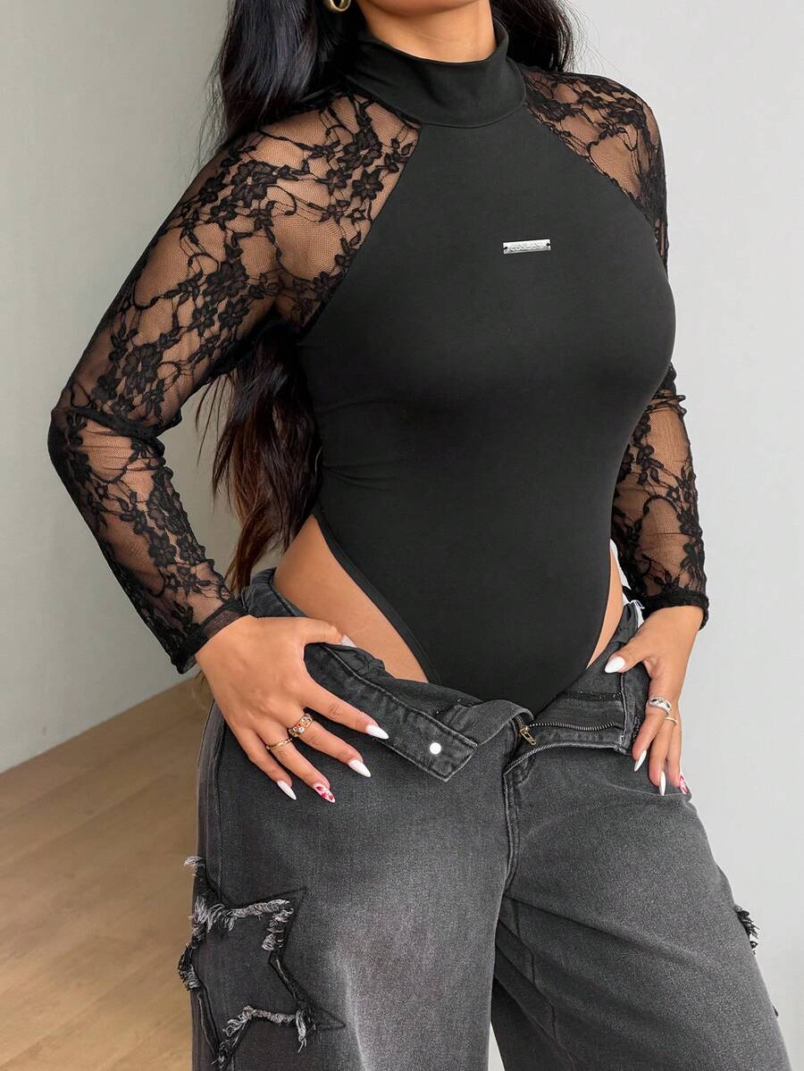 Women's black long sleeve bodysuit with sheer contrast lace raglan sleeves and stand collar.