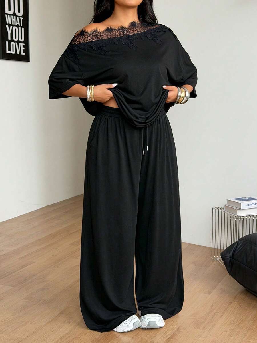 Women's casual two-piece outfit featuring a loose short-sleeve asymmetrical neck t-shirt and matching long wide leg pants with pockets.