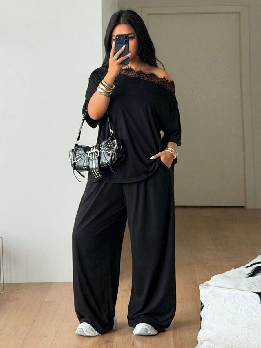 Women's casual two-piece outfit featuring a loose short-sleeve asymmetrical neck t-shirt and matching long wide leg pants with pockets.