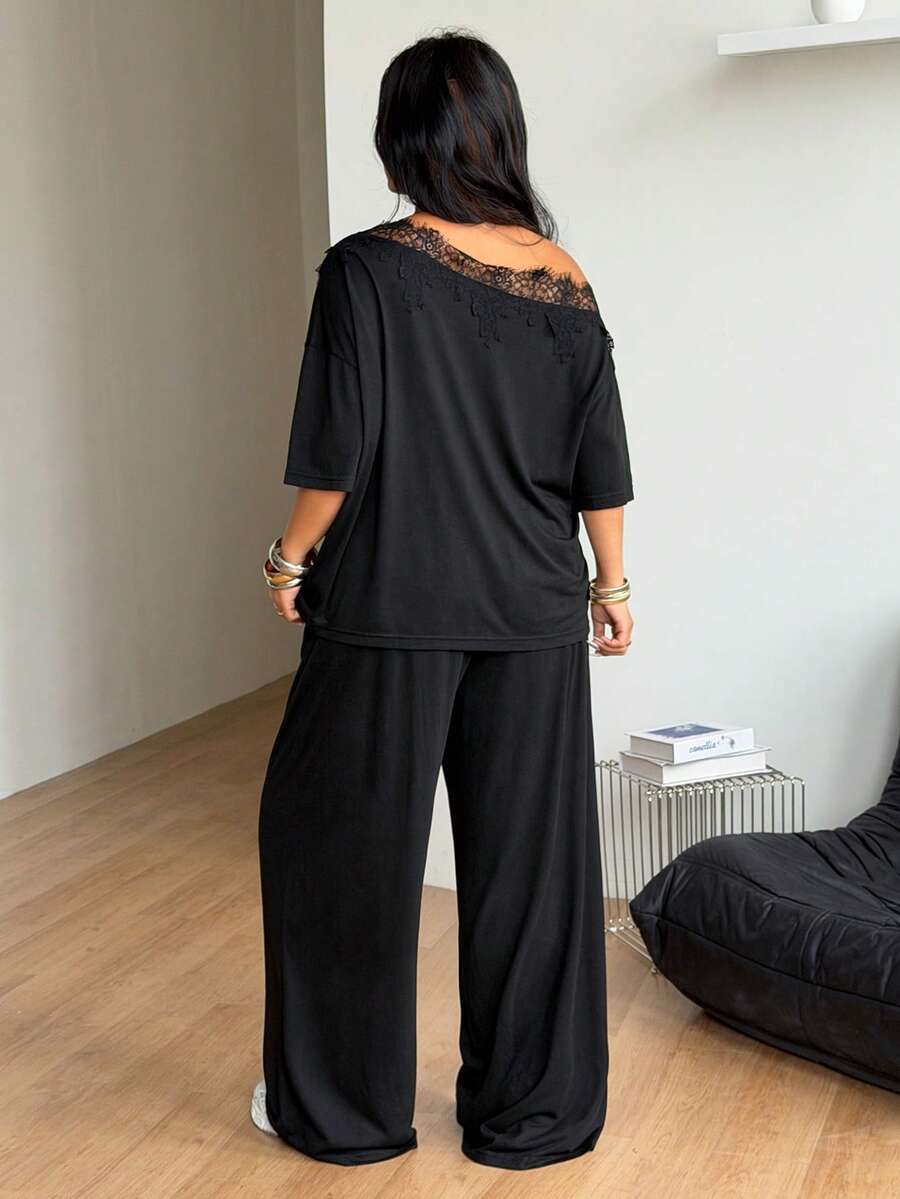 Women's casual two-piece outfit featuring a loose short-sleeve asymmetrical neck t-shirt and matching long wide leg pants with pockets.