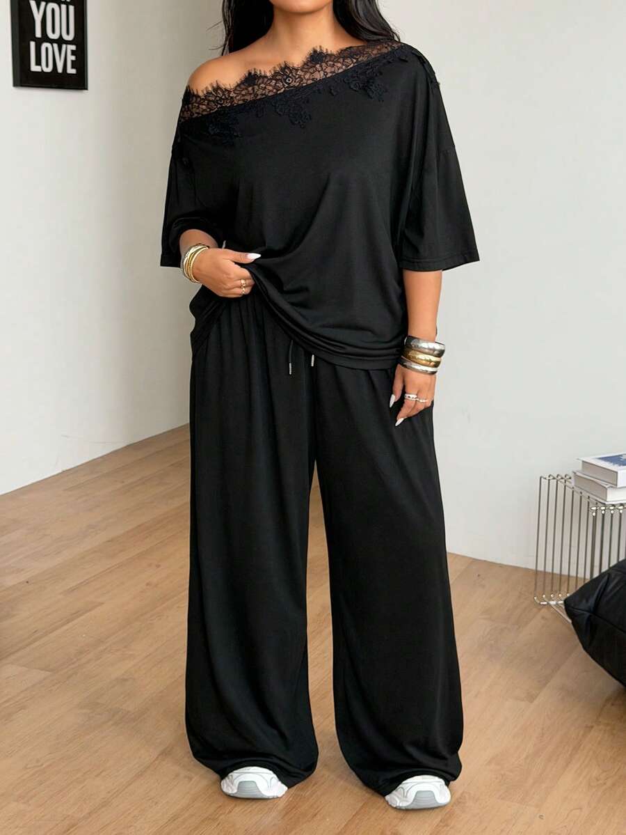 Women's casual two-piece outfit featuring a loose short-sleeve asymmetrical neck t-shirt and matching long wide leg pants with pockets.