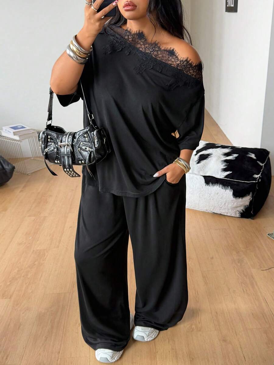 Women's casual two-piece outfit featuring a loose short-sleeve asymmetrical neck t-shirt and matching long wide leg pants with pockets.