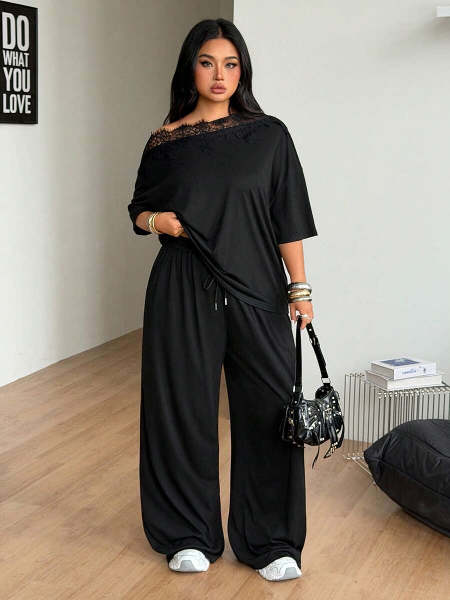 Women's casual two-piece outfit featuring a loose short-sleeve asymmetrical neck t-shirt and matching long wide leg pants with pockets.
