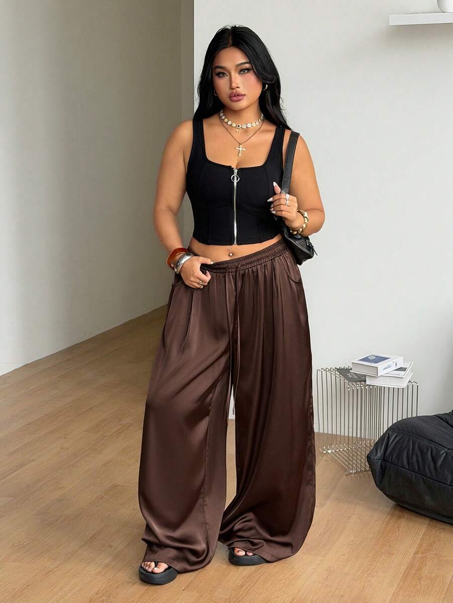 Women's loose straight leg cotton pants featuring a high waist with an adjustable drawstring knot and functional side pockets.