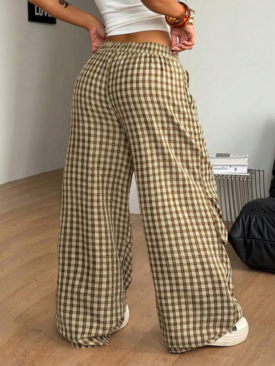 Women's black and white striped wide leg pants featuring an elastic drawstring waistband, side pockets, and a loose straight leg fit.
