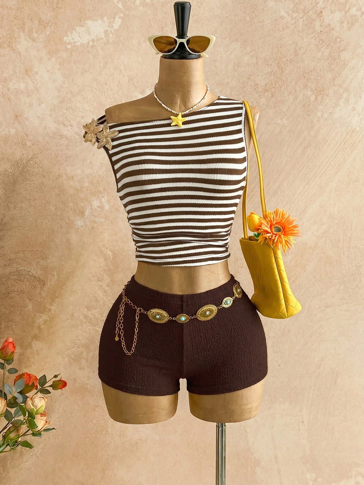 Women's black fuzzy knit two-piece set with an asymmetrical crop camisole top featuring ruched detail and cutout back, paired with matching mini shorts.