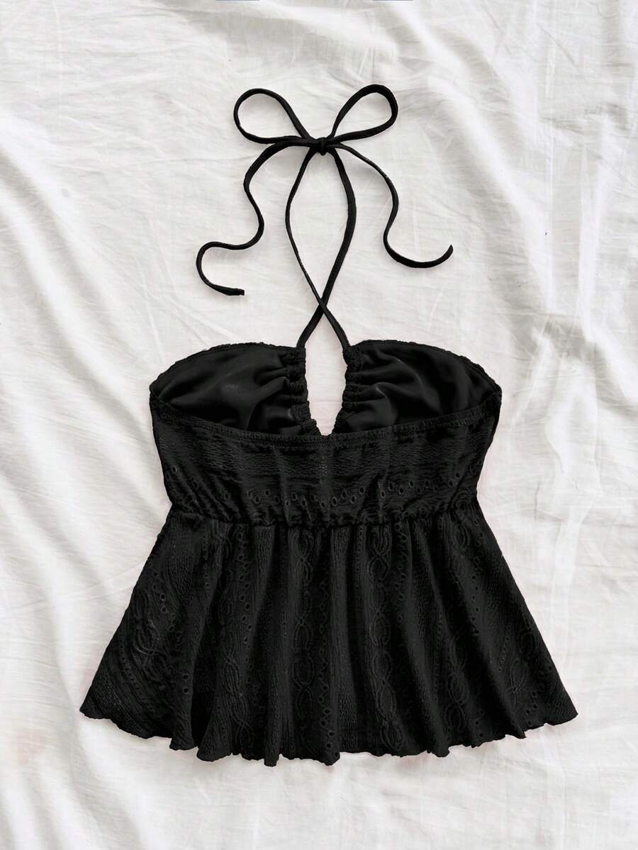 Women's textured V-neck halter tank top with backless knot detail, ruffle hem, and flared silhouette for casual beach and vacation wear.