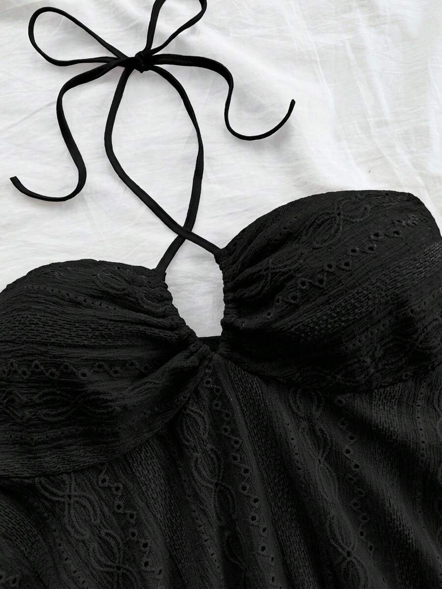 Women's textured V-neck halter tank top with backless knot detail, ruffle hem, and flared silhouette for casual beach and vacation wear.