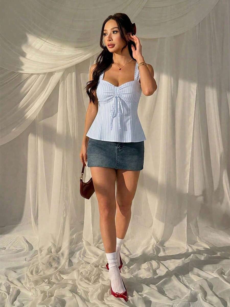 Women's striped camisole tank top with strap neckline, backless knot detail, cold shoulder styling, slim fit, and flared hem for casual vacation or daily wear.