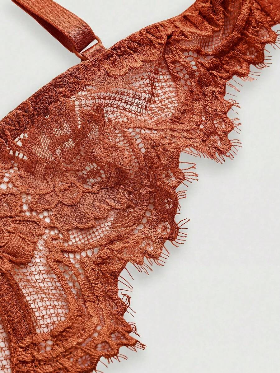 Sheer floral lace underwire triangle bra for women featuring adjustable straps and plunge cup design.