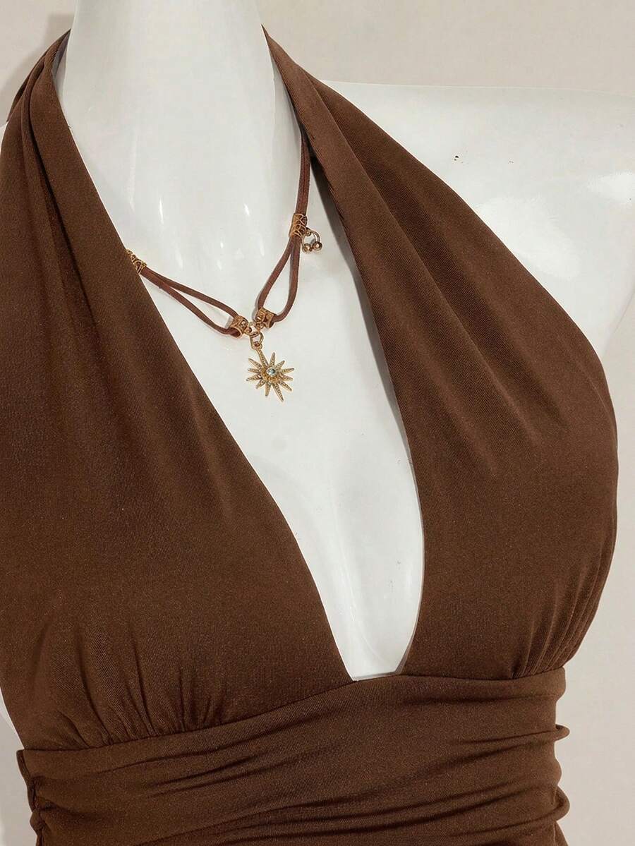 Women's backless halter babydoll tank top featuring a square neckline, slim fit silhouette, and a flared ruffle hem.