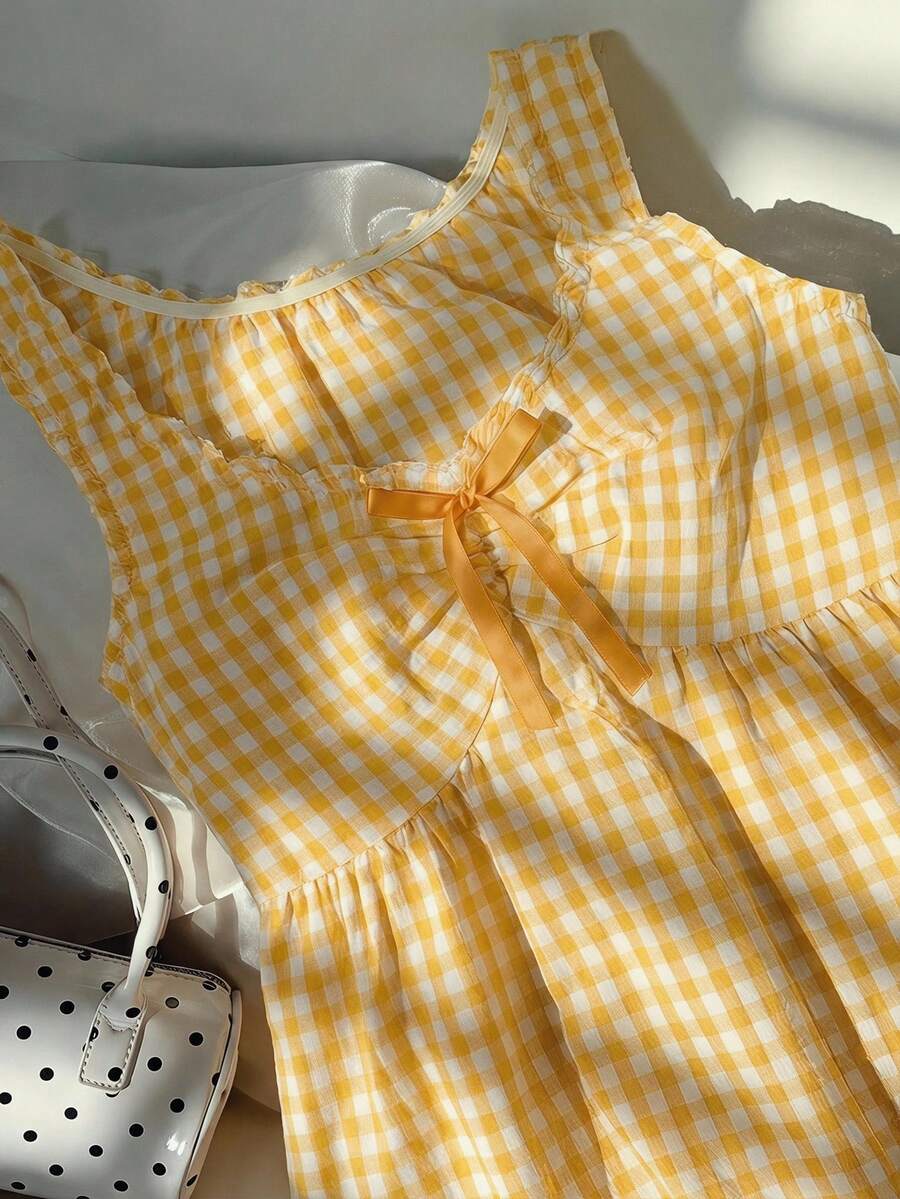Women's red gingham smocked tank top with scoop neck, ruffle hem, and bow knot detail