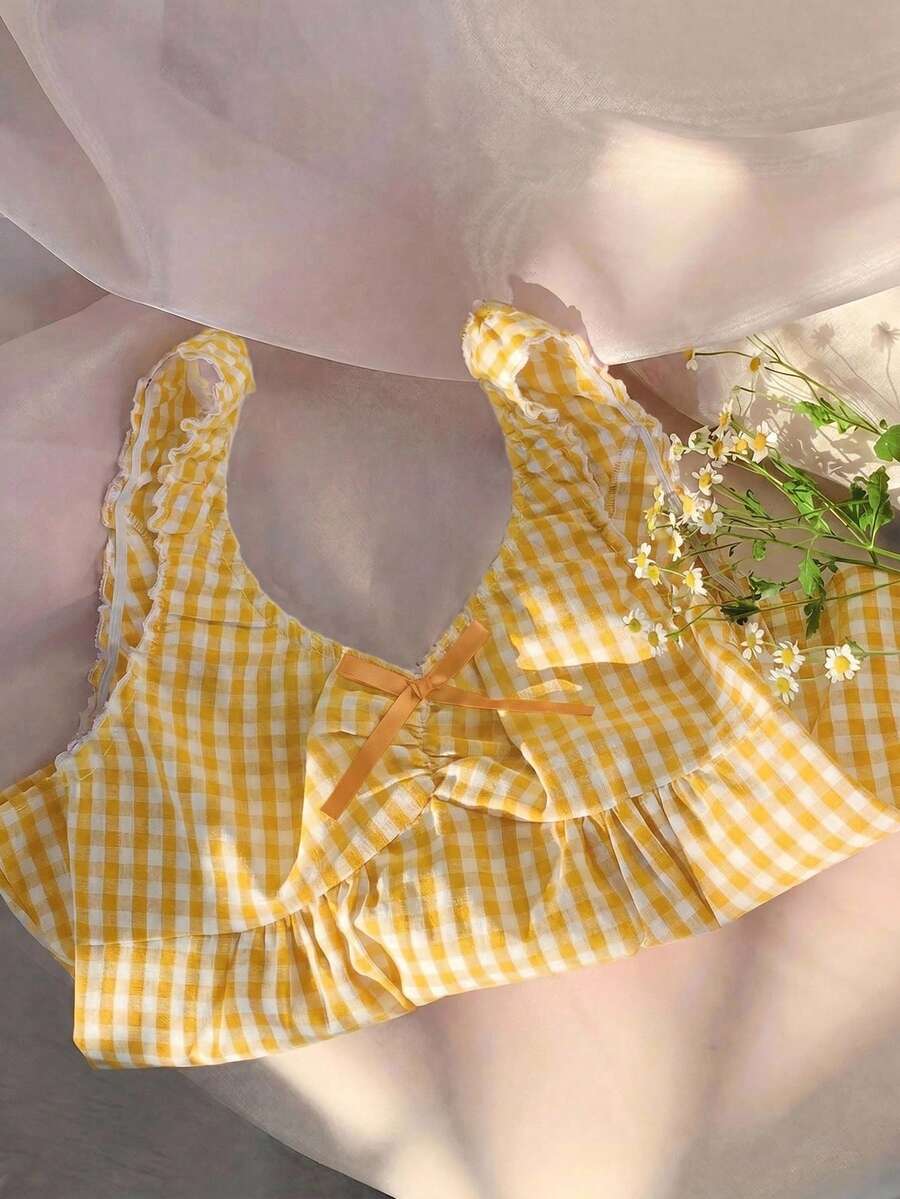 Women's red gingham smocked tank top with scoop neck, ruffle hem, and bow knot detail