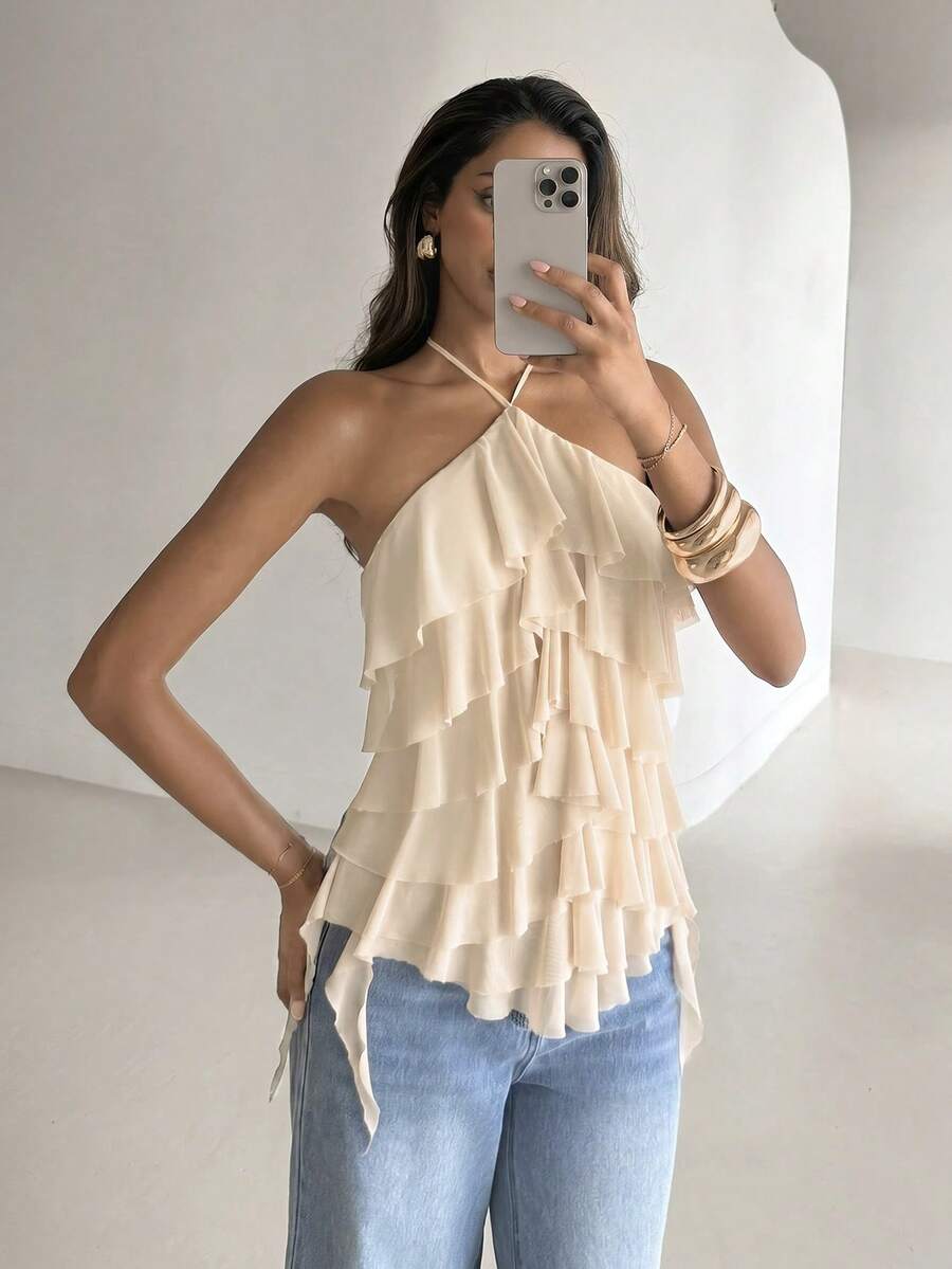 Women's sleeveless halter neck top featuring tiered ruffle layers, a backless cut, and an asymmetrical hem.