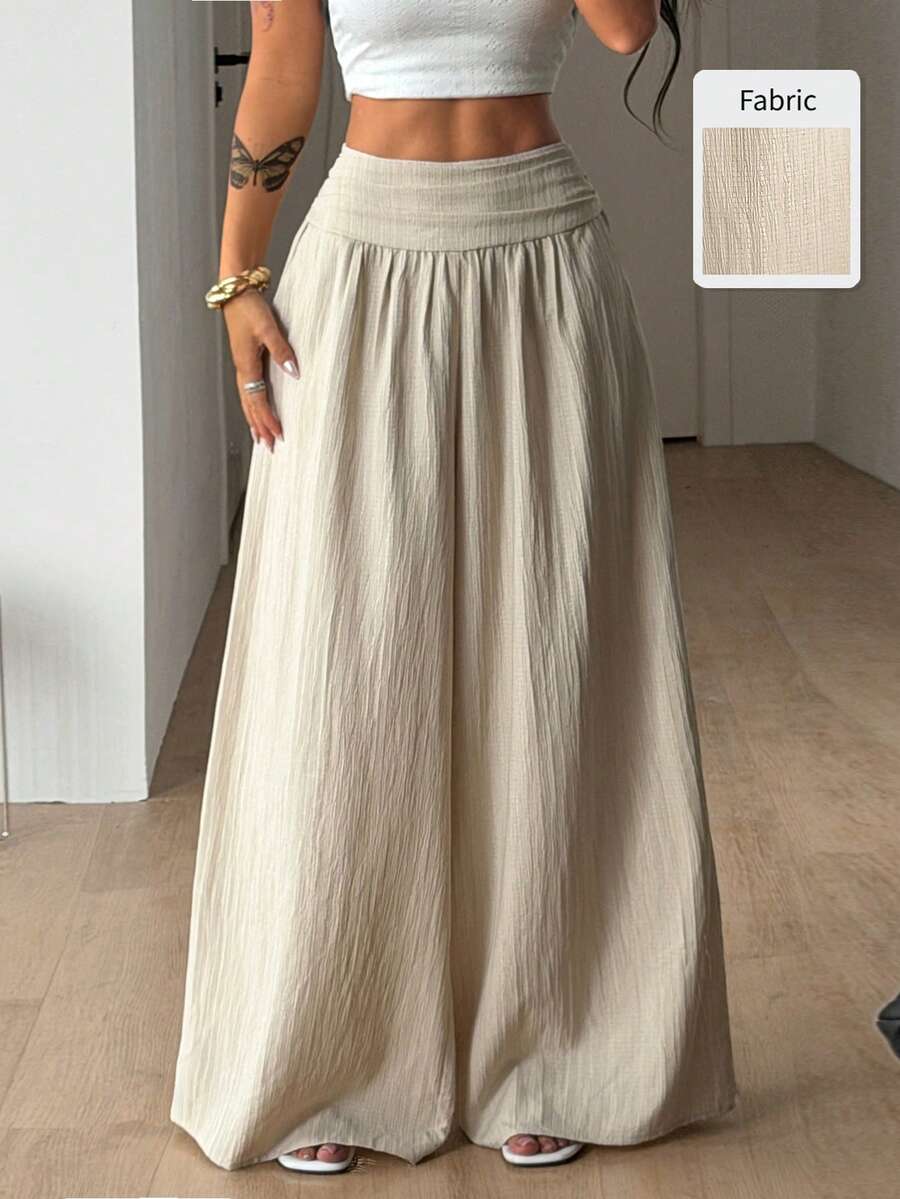 Women's plus size high-waist pleated wide leg pants in textured woven fabric with pockets