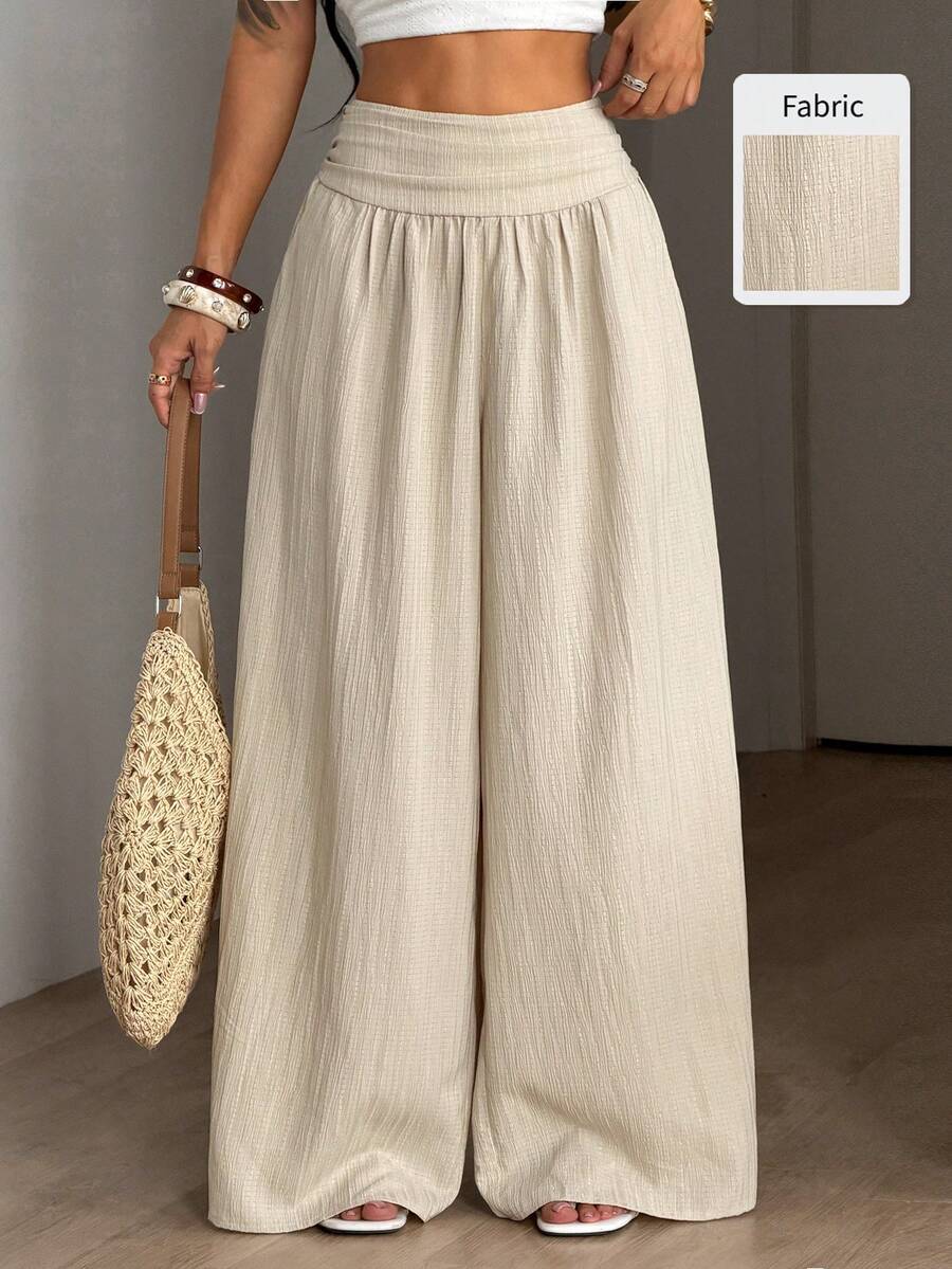 Women's plus size high-waist pleated wide leg pants in textured woven fabric with pockets