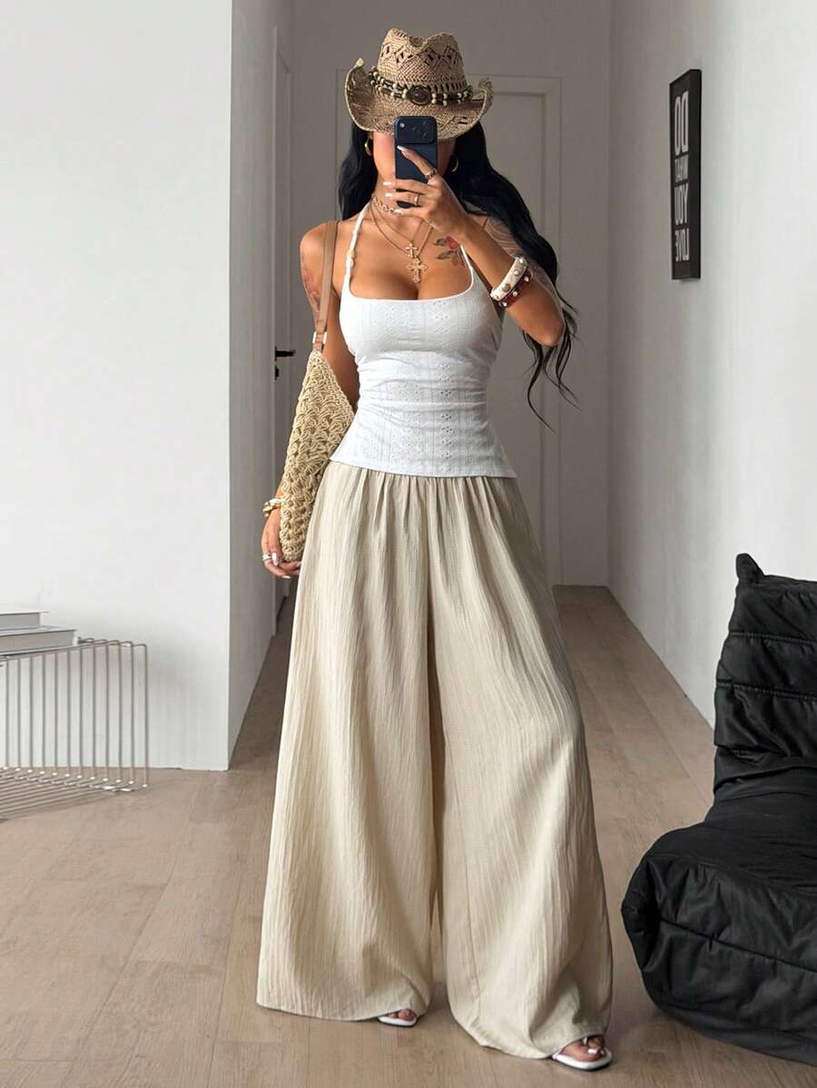 Women's plus size high-waist pleated wide leg pants in textured woven fabric with pockets