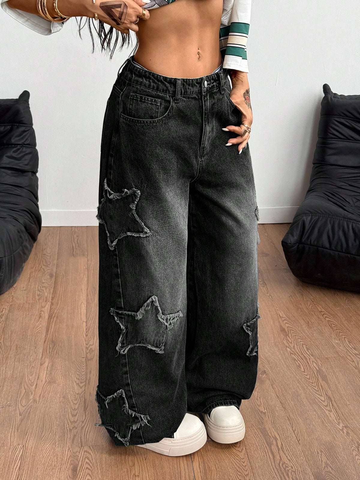 Women's loose fit baggy jeans in washed denim featuring star patches, slant pockets, and a mid-rise cut.