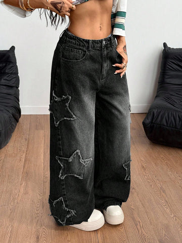 Women's loose fit baggy jeans in washed denim featuring star patches, slant pockets, and a mid-rise cut.