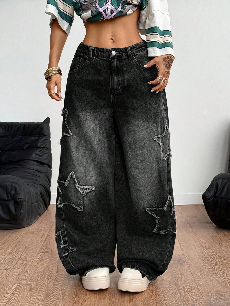 Women's loose fit baggy jeans in washed denim featuring star patches, slant pockets, and a mid-rise cut.