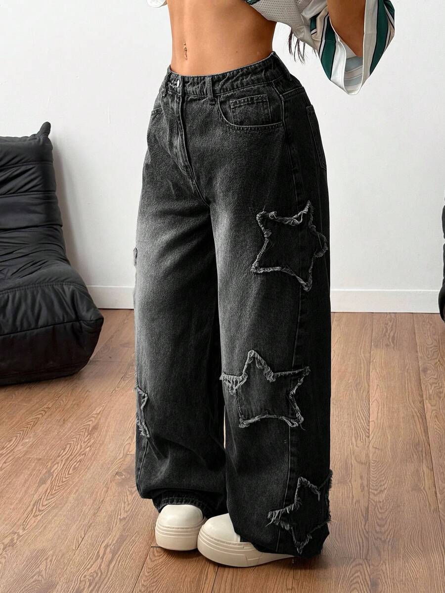 Women's loose fit baggy jeans in washed denim featuring star patches, slant pockets, and a mid-rise cut.